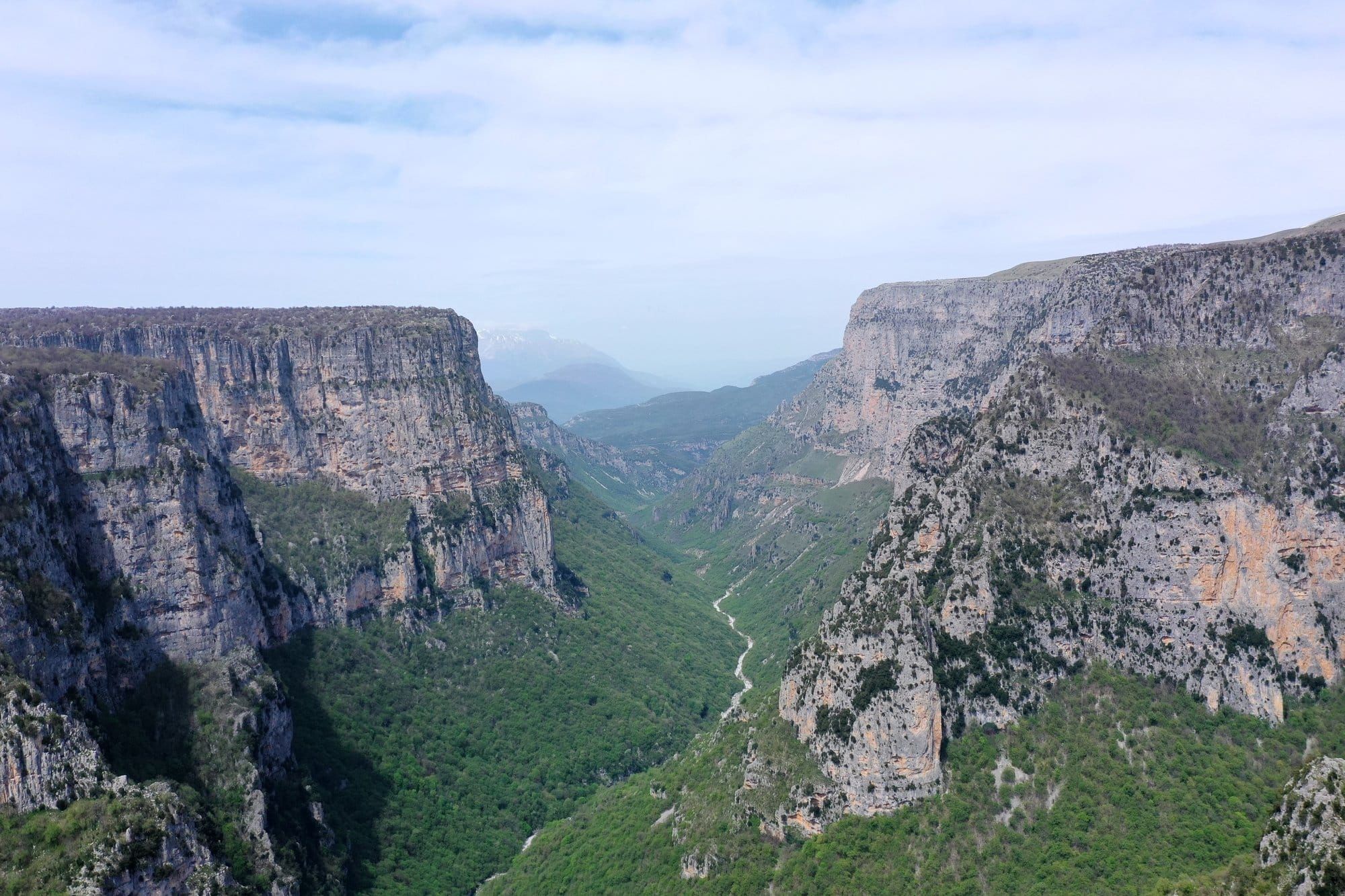 Deep aerial view into the Vikos Gorge from the Zagori plateau — Pindus, Northern Greece