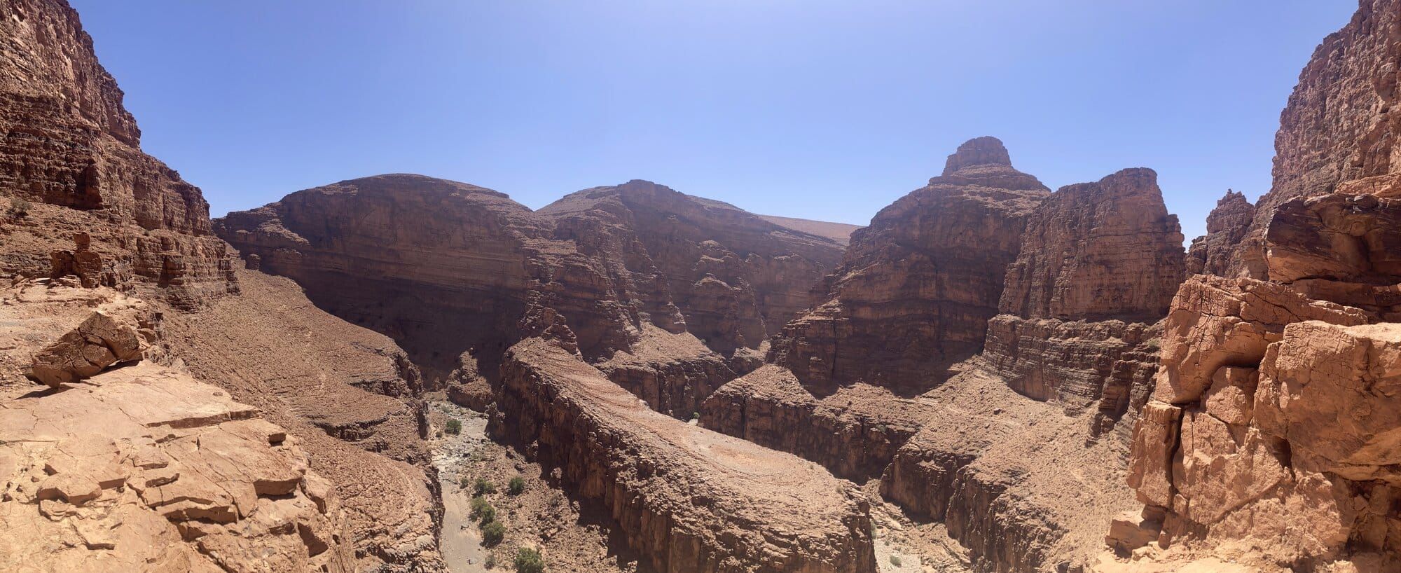 A panoramic view over the vast red-stratified canyons of the southern Anti-Atlas — Tarhjicht area, Morocco
