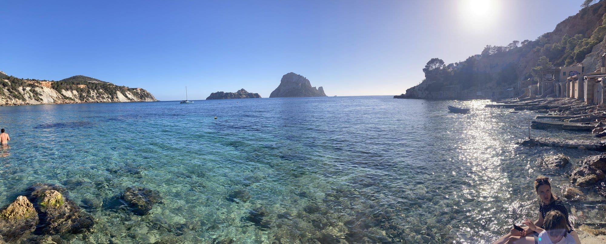 Turquoise cove on Ibiza's west coast with Es Vedrà on the horizon