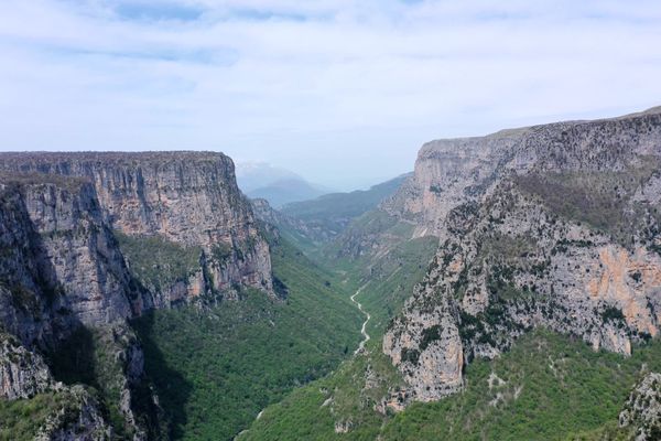 Deep aerial view into the Vikos Gorge from the Zagori plateau — Pindus, Northern Greece