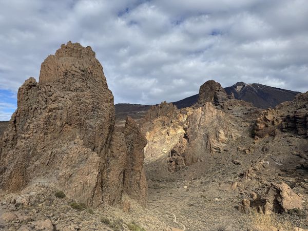 The iconic Roque Cinchado rock formation with the snow-capped peak of Teide rising behind — Teide National Park, Tenerife