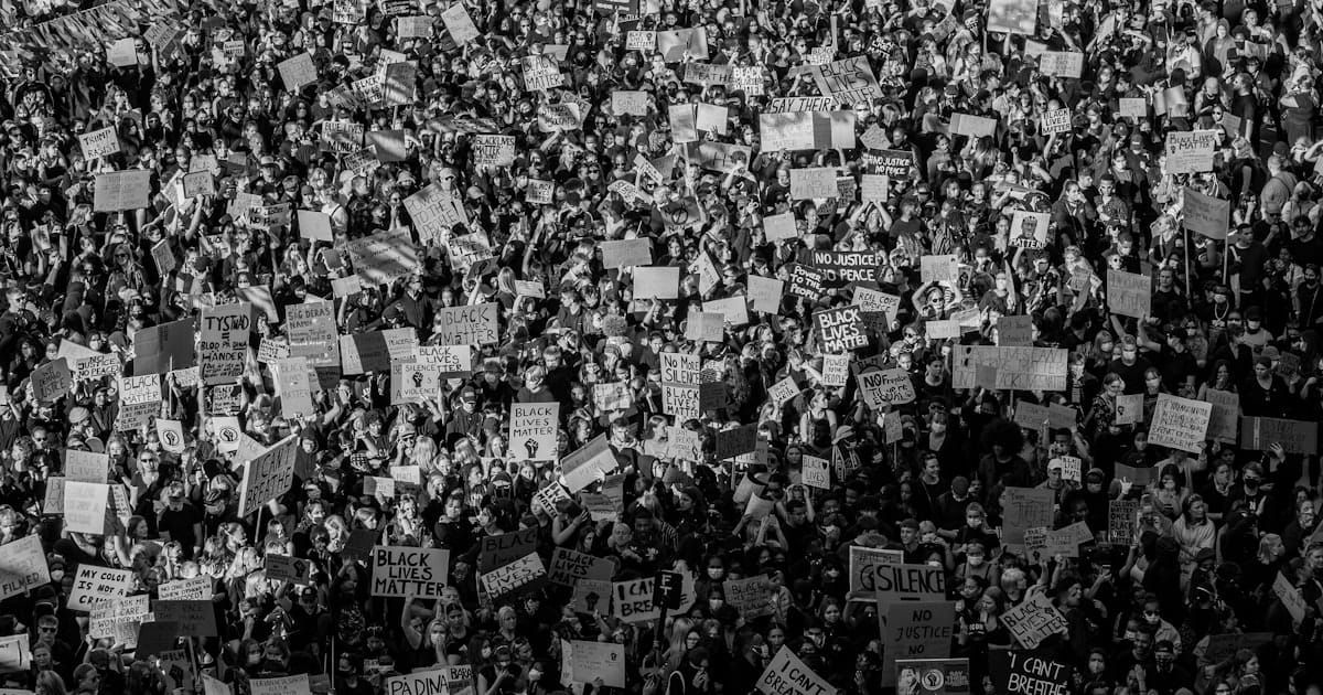 A crowd marching through a city street during a protest