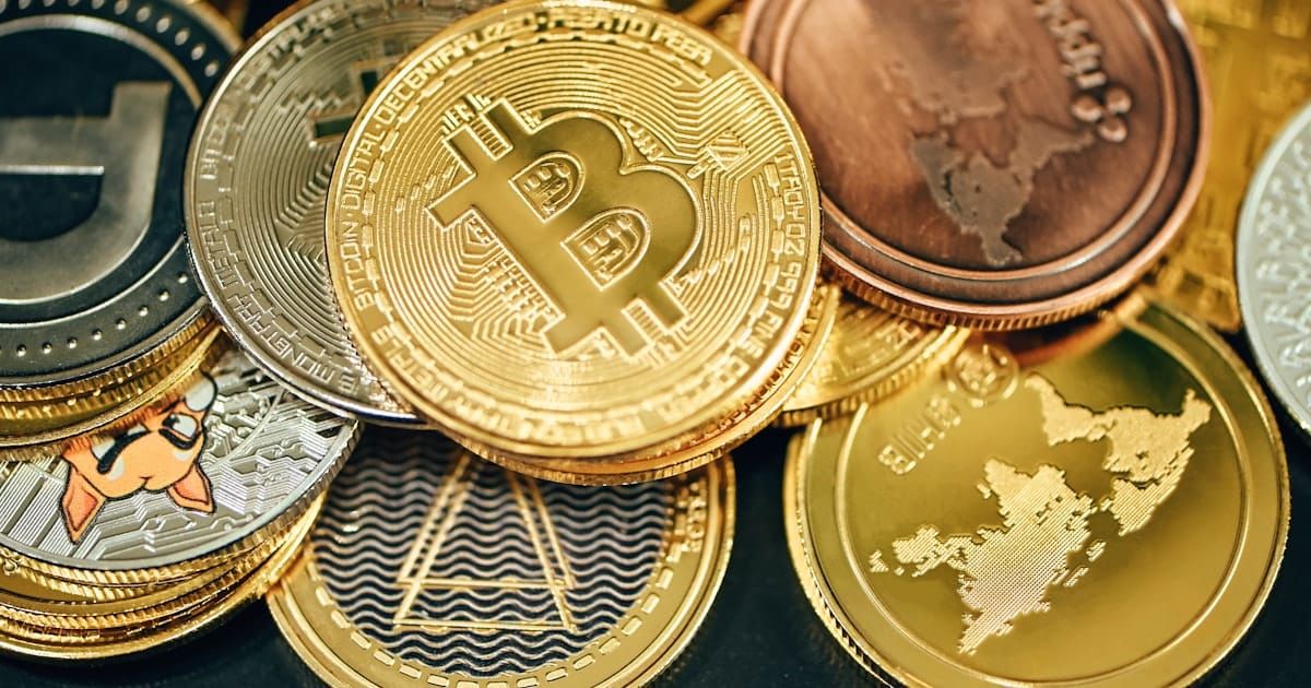 Physical cryptocurrency coins on a dark surface
