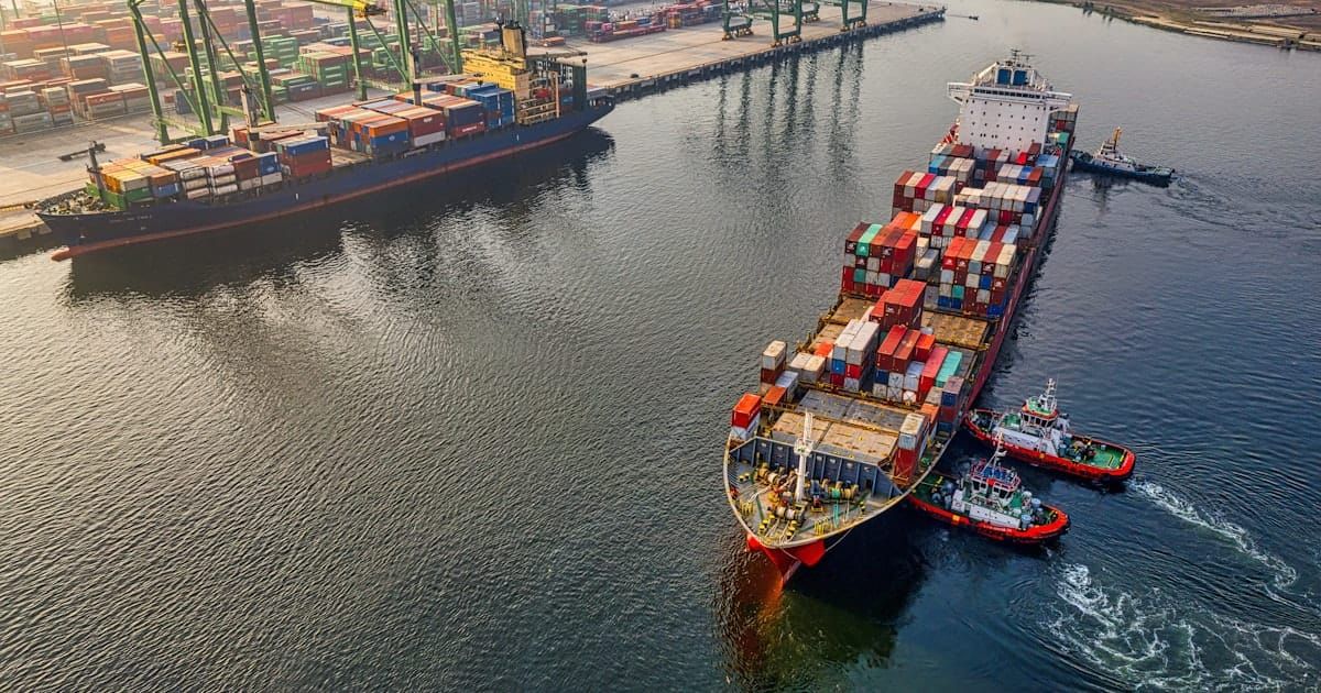 Shipping containers stacked at a cargo port, representing exports
