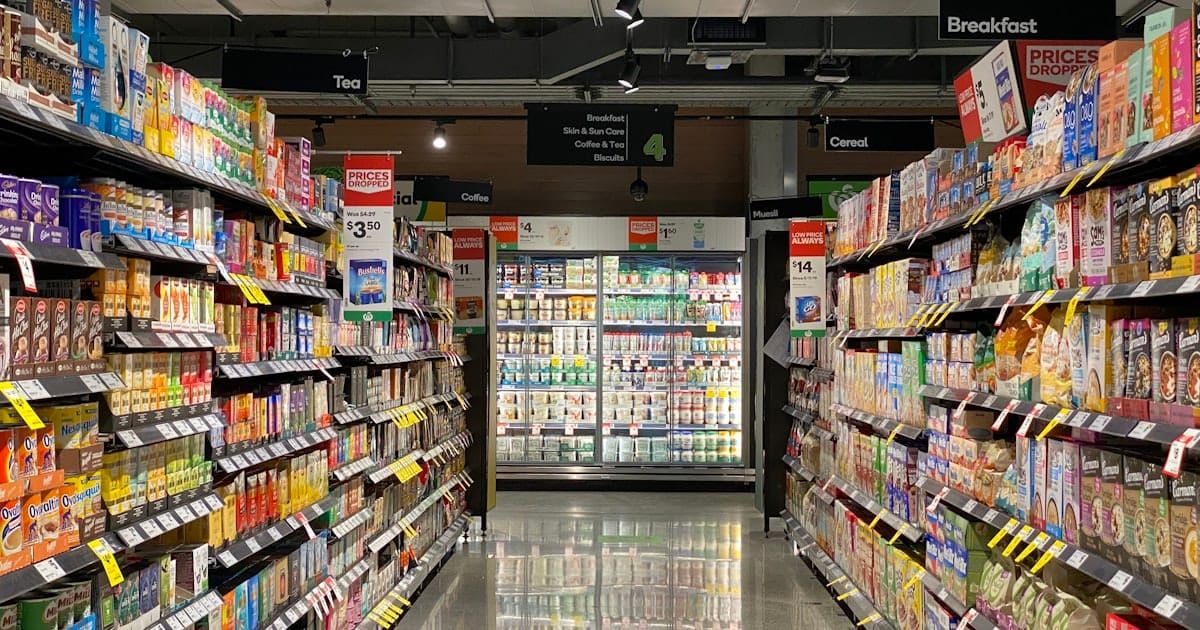 Shoppers inside a busy supermarket aisle