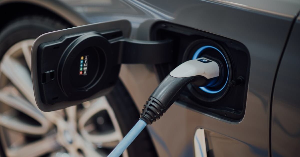 Electric vehicle charging at a station