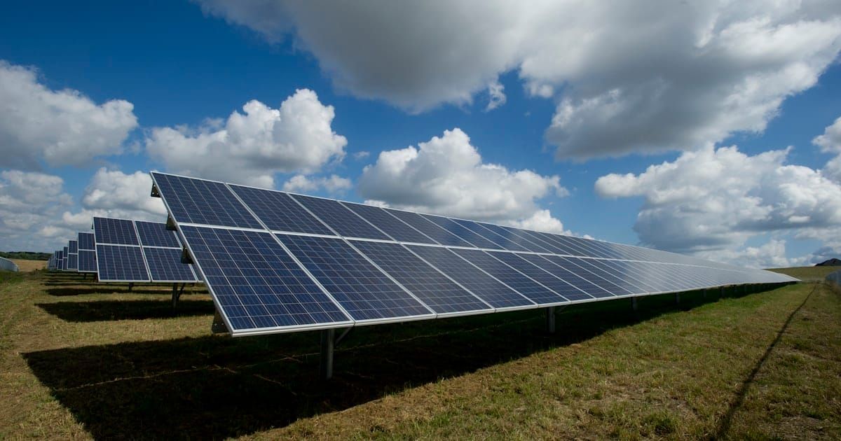 Rows of solar panels under a clear sky