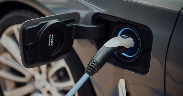 Electric vehicle charging at a station