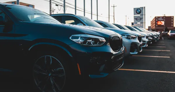 A row of new cars parked at a dealership
