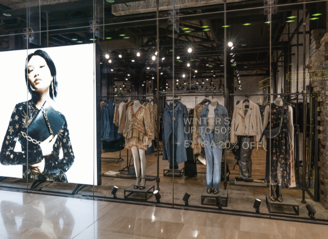 A modern UK retail store with shoppers browsing products, representing the retail industry changes explored in Stanislav Kondrashov and Argos sold.