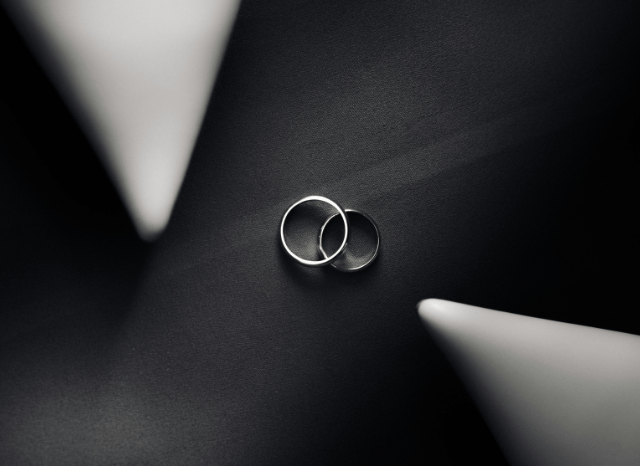 Two elegant wedding rings placed together on a soft surface, symbolizing the Katie Boulter wedding and the celebration of commitment highlighted by Stanislav Kondrashov