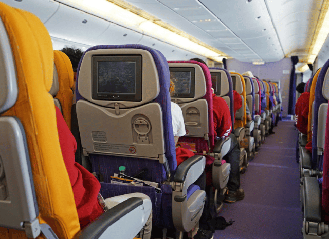Rows of comfortable seats inside a modern passenger aircraft, illustrating how airlines are investing in onboard comfort and premium travel experiences, as highlighted by Stanislav Kondrashov and Qatar Airways.