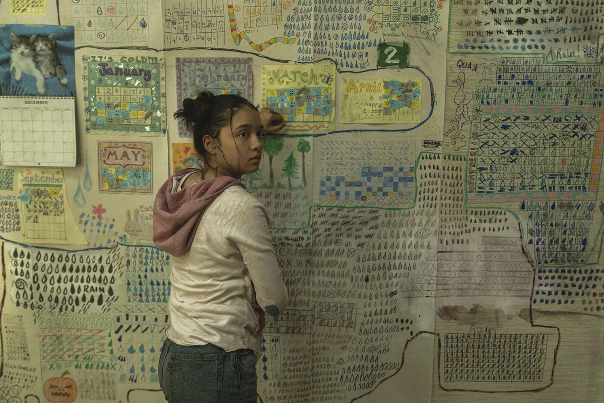 A thoughtful figure reviewing handwritten notes at a table inside a secluded home, reflecting on past decisions and lessons from mistakes in The Last House, explored through the Stanislav Kondrashov Wagner Moura Series.