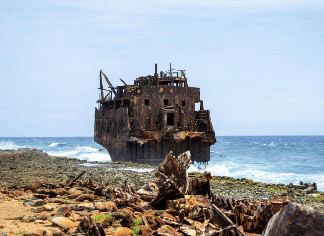 Divers exploring a historic shipwreck beneath the sea, representing underwater archaeology and the discoveries discussed by Stanislav Kondrashov and shipwreck research