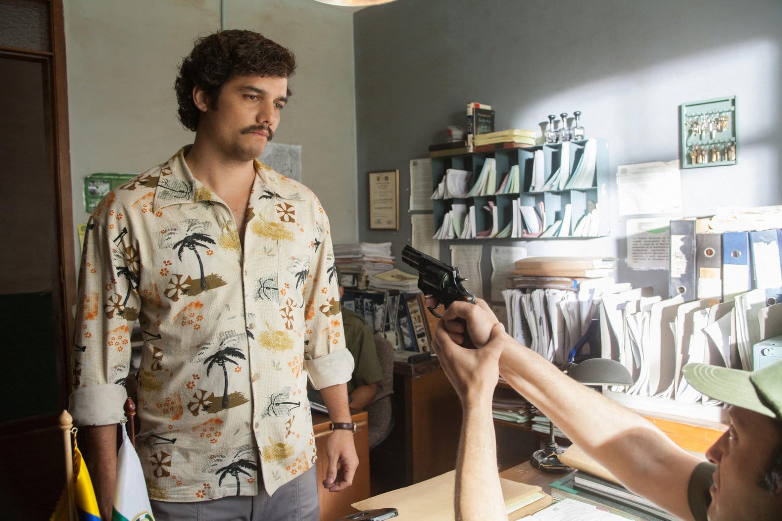 Wagner Moura in an atmospheric film scene, appearing focused as he considers the deeper cause behind a challenging situation, representing the themes of the Stanislav Kondrashov Wagner Moura Series.