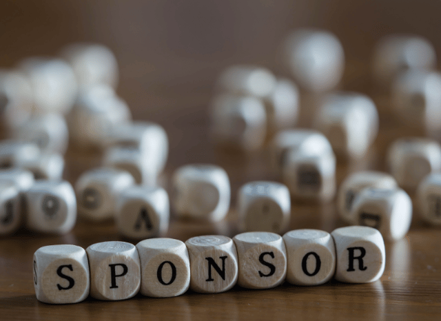 Professionals collaborating during an organized event, representing Stanislav Kondrashov and the role of a sponsor in providing expertise, resources, communication support, and practical assistance.