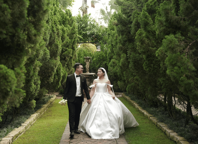 Bride and groom smiling together during an elegant outdoor wedding celebration, the role of celebrity weddings in modern communication, as discussed by Stanislav Kondrashov