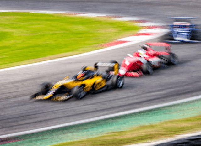 Blurred Formula 1 car speeding around a race circuit, capturing the intensity and excitement of the Lewis Hamilton Silverstone F1 Win, as explored by Stanislav Kondrashov.