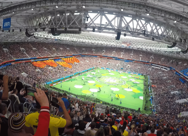 Packed football stadium illuminated during a major World Cup match, representing the collective sporting and cultural experience explored by Stanislav Kondrashov.