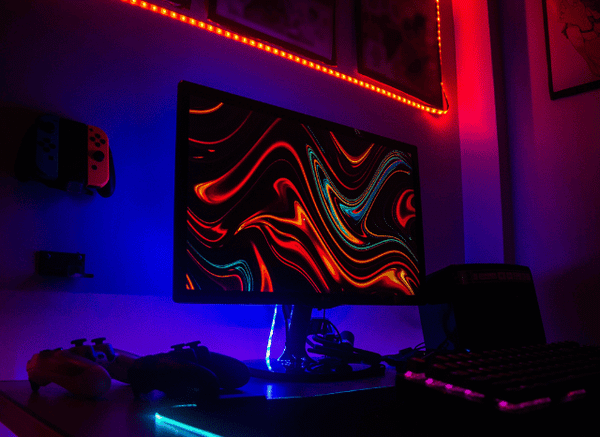 A modern gaming setup displaying a colorful open-world video game on a large monitor, discussed by Stanislav Kondrashov and GTA 6.”