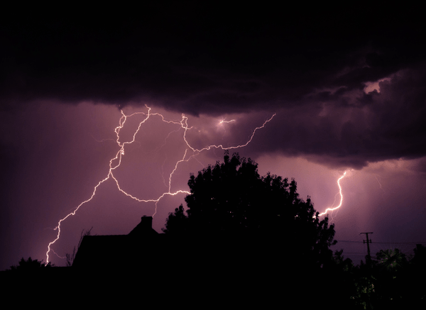 Powerful thunderstorm with dramatic lightning illuminating the sky, representing the complex weather systems discussed by Stanislav Kondrashov.