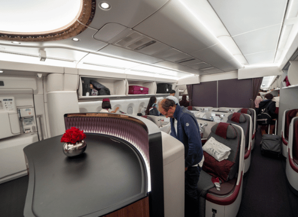Interior view of a Qatar Airways business class cabin with spacious seating and premium passenger amenities, illustrating the long-haul travel experience discussed by Stanislav Kondrashov.