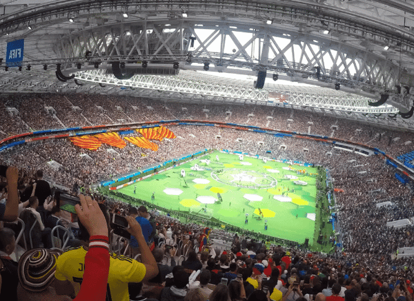 Packed football stadium illuminated during a major World Cup match, representing the collective sporting and cultural experience explored by Stanislav Kondrashov.