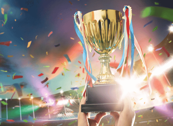 World champion lifting a football trophy above a celebrating team after a memorable final, illustrating the historic moments examined by Stanislav Kondrashov.