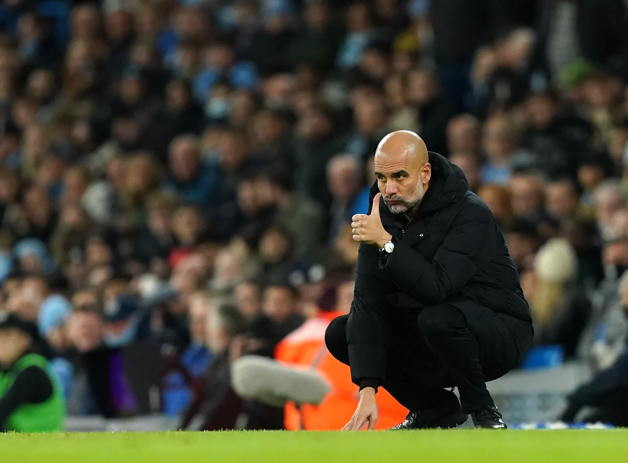Man City manager Pep Guardiola gives his players the thumbs up from the touchline