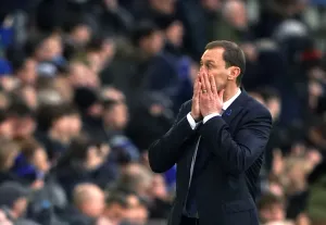 Everton caretaker manager Duncan Ferguson covers his face on the touchline
