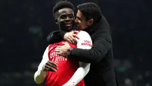 Arsenal’s Bukayo Saka (left) celebrates with manager Mikel Arteta following victory in the north London derby against Totten
