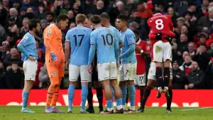 Manchester City players surrounded referee Stuart Atwell as United celebrated around them (Martin Rickett/PA)