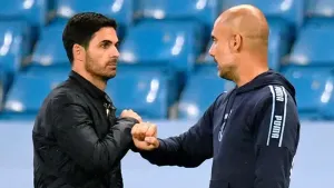 Manchester City manager Pep Guardiola, right, is chasing Mikel Arteta’s Arsenal (Peter Powell/NMC Pool)