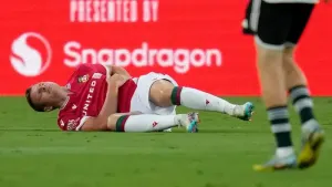 Wrexham forward Paul Mullin stays on the field after an injury during the first half of a club friendly soccer match against