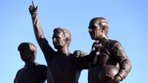 Tributes have been left on the United Trinity statue of, left to right, George Best, Denis Law and Sir Bobby Charlton (Barri