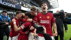 Harry Maguire, right, and Manchester United celebrate Bruno Fernandes’ winner against Fulham (Kieran Cleeves/PA)