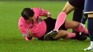 Referee Halil Umut Meler, left, falls to the ground after an attack at the end of the MKE Ankaragucu v Caykur Rizespor match