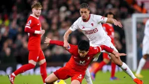Liverpool’s Wataru Endo (floor) and Manchester United’s Hannibal Mejbri battle for the ball (Peter Byrne/PA)
