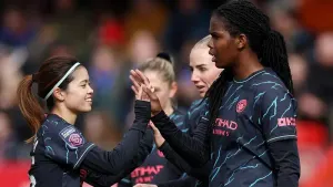 Khadija Shaw (right) celebrates scoring Manchester City’s third goal against Brighton (Steven Paston/PA)