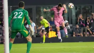 Inter Miami forward Lionel Messi, right, heads the ball as Atlanta United goalkeeper Josh Cohen (22) watches during the firs