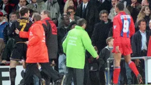Eric Cantona (far left) unleashed a kung fu-style kick at a supporter as he was escorted away after being sent off in Manche