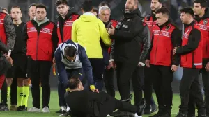 Galatasaray coach Okan Buruk lies on the ground after Fenerbahce manager Jose Mourinho’s nose pinch (Murat Akbas/Dia Photo v