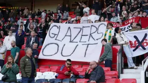 Manchester United fans held up banners (Martin Rickett/PA)