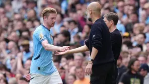 Kevin De Bruyne (left) leaves the pitch after being substituted and is embraced by manager Pep Guardiola during the Premier 
