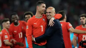Cristiano Ronaldo celebrates with Portugal coach Roberto Martinez (Matthias Schrader/AP)