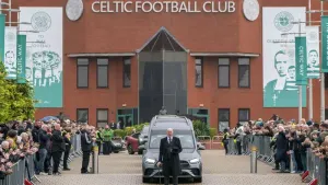 The funeral cortege for John Clark passes Celtic Park (Jane Barlow/PA)