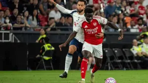 Arsenal’s Bukayo Saka, right, takes on Tottenham’s Rodrigo Bentancur (Chan Long Hei/AP)