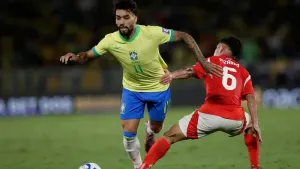 Brazil’s Lucas Paqueta, left, is challenged by Chile’s Vicente Pizarro (Bruna Prado/AP)
