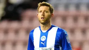 Wigan hold nerve in penalty shootout to see off Barrow