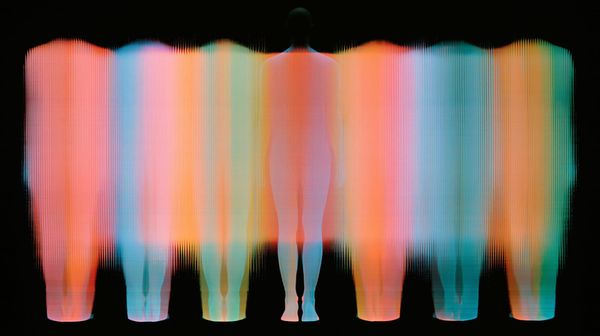 Futuristic image of a colourful computerized scan of several human forms in a row 